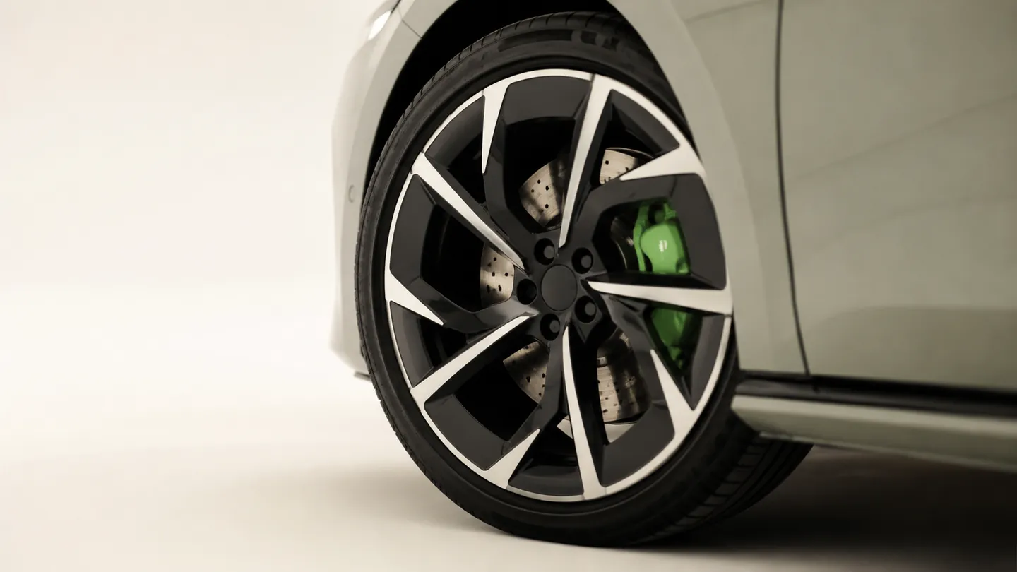 A close-up of an electric car's alloy wheel and brake disc, hinting at rust on a rarely used disc