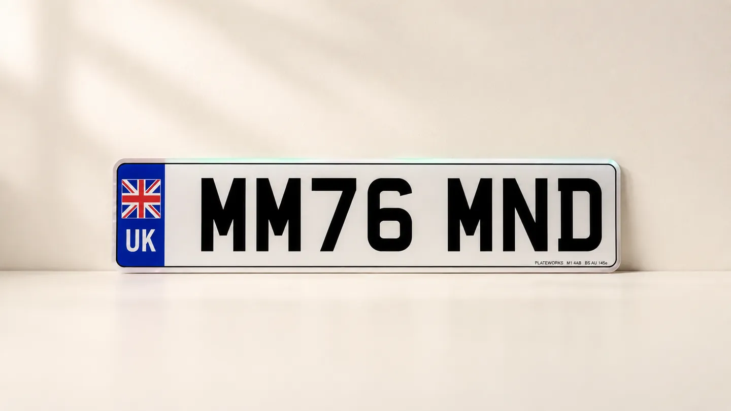 A row of new cars on a UK dealer forecourt, number plates visible, on plate-change day